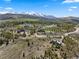 Expansive aerial view showcasing the property's location surrounded by lush greenery and mountain vistas at 23 Verde Ct, Breckenridge, CO 80424