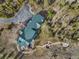 Aerial view of a home featuring a metal roof, outdoor entertaining area, and wooded surroundings at 23 Verde Ct, Breckenridge, CO 80424