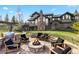 Landscaped backyard with a fire pit, grill, and seating area, perfect for outdoor entertaining at 23 Verde Ct, Breckenridge, CO 80424