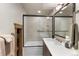 Modern bathroom with a glass-enclosed shower/tub combo, contemporary vanity, and neutral color palette at 23 Verde Ct, Breckenridge, CO 80424