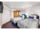 Comfortable bedroom with twin beds, stylish blue headboards and a rustic wood door at 23 Verde Ct, Breckenridge, CO 80424