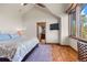 Bright bedroom featuring hardwood floors, ensuite bathroom, and large window with natural light at 23 Verde Ct, Breckenridge, CO 80424