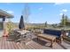 Outdoor deck with comfortable seating, dining table, and mountain views for relaxing and entertaining at 23 Verde Ct, Breckenridge, CO 80424