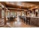 Spacious dining room and breakfast bar featuring wood beams, wood floors, and large windows with natural light at 23 Verde Ct, Breckenridge, CO 80424