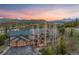 Luxury home with an attached three-car garage, with a view of snow-capped mountains and an orange sunset at 23 Verde Ct, Breckenridge, CO 80424