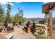 Inviting outdoor area with a fire pit, grill and seating area with mountain views at 23 Verde Ct, Breckenridge, CO 80424