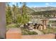 Beautiful outdoor area featuring a stone firepit and seating surrounded by mountain views at 23 Verde Ct, Breckenridge, CO 80424