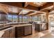 Open kitchen with wooden cabinets, quartz countertops, and large windows overlooking scenic mountain views at 23 Verde Ct, Breckenridge, CO 80424