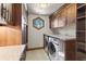 Clean laundry room with built-in cabinets, granite countertop, and stacked washer and dryer at 23 Verde Ct, Breckenridge, CO 80424