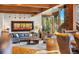 Comfortable living room featuring a stone fireplace, large windows and beautiful nature views at 23 Verde Ct, Breckenridge, CO 80424