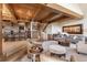 Open living space featuring hardwood floors, breakfast bar and comfortable seating around a stone fireplace at 23 Verde Ct, Breckenridge, CO 80424