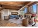 Cozy living room with stone fireplace, exposed wood beams and an abundance of natural light at 23 Verde Ct, Breckenridge, CO 80424