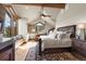 Bright main bedroom featuring beamed ceilings, a window seat with picturesque mountain views, and a luxurious rug at 23 Verde Ct, Breckenridge, CO 80424