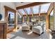 Bright sunroom with floor to ceiling windows with an adjoined outdoor terrace at 23 Verde Ct, Breckenridge, CO 80424
