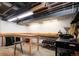 Functional basement area featuring work tables, storage solutions, and ample space for projects at 675 S University Blvd # 106, Denver, CO 80209