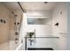 This bathroom has a modern glass counter top and unique sink with a shower/tub combo with neutral toned walls at 675 S University Blvd # 106, Denver, CO 80209