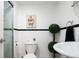 This charming bathroom features white subway tiles, black accent stripes, and an 'Oh Happy Day' wall decor at 675 S University Blvd # 106, Denver, CO 80209