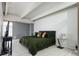 Comfortable bedroom with a cozy green bedspread, unique ceiling beams, and a sleek side table at 675 S University Blvd # 106, Denver, CO 80209