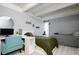This bedroom features neutral gray walls, wooden floors, a comfortable bed, and a well-lit desk area for work or study at 675 S University Blvd # 106, Denver, CO 80209