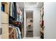 Organized closet with built-in shelving and access to a well-lit bathroom with modern fixtures at 675 S University Blvd # 106, Denver, CO 80209