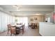 Bright dining area featuring multiple tables and chairs, with sheer curtains and neutral tones at 675 S University Blvd # 106, Denver, CO 80209