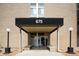 Building entrance with covered walkway, minimalist design, and well-maintained landscaping at 675 S University Blvd # 106, Denver, CO 80209