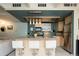 Kitchen featuring stainless steel appliances, an island with bar stools, and modern lighting at 675 S University Blvd # 106, Denver, CO 80209