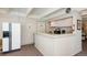 This community kitchenette with white cabinets, appliances and countertop space offers an area for refreshments at 675 S University Blvd # 106, Denver, CO 80209