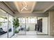 Bright living room features unique light fixture, modern sliding glass doors, and stylish decor at 675 S University Blvd # 106, Denver, CO 80209