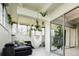 Bright living room with white ceiling beams, hanging hammock, and access to the outside at 675 S University Blvd # 106, Denver, CO 80209