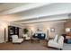 Comfortable living room with stylish seating, including a blue sofa, patterned chairs, and ample lighting at 675 S University Blvd # 106, Denver, CO 80209