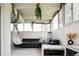 Spacious living room with large windows, stylish seating arrangements, and modern décor at 675 S University Blvd # 106, Denver, CO 80209