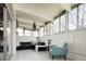 Brightly lit living room with large windows, comfortable seating and hanging decorative accents at 675 S University Blvd # 106, Denver, CO 80209