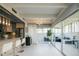 Bright living room with kitchen and a sunroom featuring floor to ceiling windows at 675 S University Blvd # 106, Denver, CO 80209