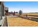 Wide backyard featuring a patio dining set, open fields, and distant houses under a clear sky at 11545 S Flower Mound Way, Parker, CO 80134