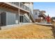 View of the backyard with patio, lawn, lower deck with a shed, and stairs to the upper deck at 11545 S Flower Mound Way, Parker, CO 80134