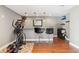 Basement bar area with a sink, stools, granite countertops, and exercise equipment at 11545 S Flower Mound Way, Parker, CO 80134