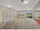 Spacious basement area with neutral carpet and sliding door to outside, perfect for entertaining at 11545 S Flower Mound Way, Parker, CO 80134