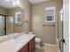 Well-lit bathroom features a shower, toilet, vanity, and neutral color scheme at 11545 S Flower Mound Way, Parker, CO 80134