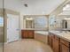 Spacious bathroom with double vanity, soaking tub, and tile flooring at 11545 S Flower Mound Way, Parker, CO 80134