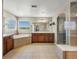 Luxurious bathroom with separate shower, soaking tub, double vanity, and large mirror at 11545 S Flower Mound Way, Parker, CO 80134