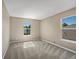 Simple bedroom with gray carpet and two windows at 11545 S Flower Mound Way, Parker, CO 80134