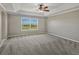 Bright bedroom with tray ceiling, lots of light from a big window, and neutral colored carpet at 11545 S Flower Mound Way, Parker, CO 80134