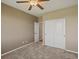 Cozy bedroom with plush carpeting, a ceiling fan, and a closet at 11545 S Flower Mound Way, Parker, CO 80134