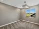 Bright bedroom featuring a large window with views of the lush surrounding landscape at 11545 S Flower Mound Way, Parker, CO 80134
