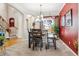 Well-lit dining room with a modern chandelier, large windows, and a vibrant accent wall at 11545 S Flower Mound Way, Parker, CO 80134