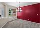 Inviting dining room with large window, stylish chandelier, and accent wall at 11545 S Flower Mound Way, Parker, CO 80134