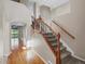 Inviting entryway with wood floors, staircase with iron spindles, and view of the backyard at 11545 S Flower Mound Way, Parker, CO 80134