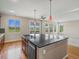 Bright, open kitchen features a large island, wood cabinets, and patio access at 11545 S Flower Mound Way, Parker, CO 80134