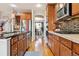 Modern kitchen featuring wood floors, stainless appliances, and wood cabinets at 11545 S Flower Mound Way, Parker, CO 80134